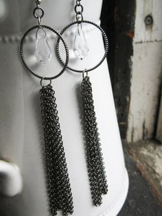 I've become a bit of an art deco fan and I love the jewelry of the 20s and 30s. I designed these long chain earrings with inspiration from those fashions.  Measuring about 5" long in total, these earrings are made with gunmetal chain, 1" gunmetal hoops and larger 17mm x 10mm clear Austrian crystals. They have some nice weight and are a one of a kind design.  ** For more fun items enter my shop here ** http://www.etsy.com/shop/whatanovelidea?ref=si_shop 20s Jewelry, Style Année 20, 20s Style, Art Deco Fan, Long Chain Earrings, Earrings Art, Great Gatsby, Austrian Crystal, Long Chain