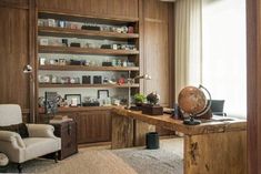 a living room filled with lots of furniture and bookshelves next to a window