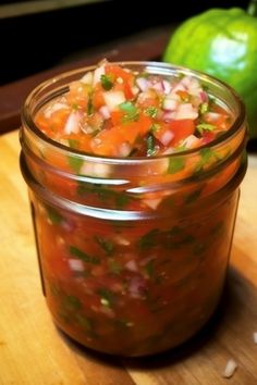 a jar filled with lots of food sitting on top of a wooden table