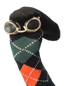 a pair of glasses sitting on top of a black sock with green and orange plaid