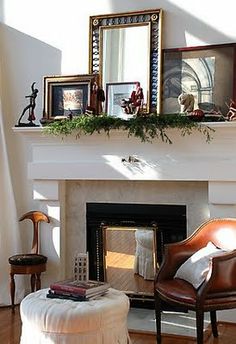 a living room with a fire place and pictures on the mantle