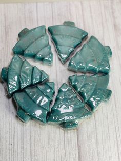 several pieces of green pottery sitting on top of a wooden table