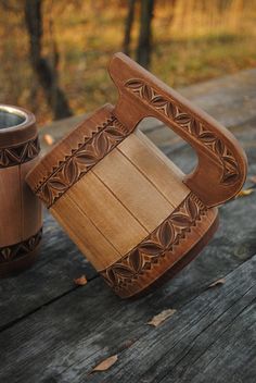 two wooden vases sitting on top of a wooden picnic table next to each other