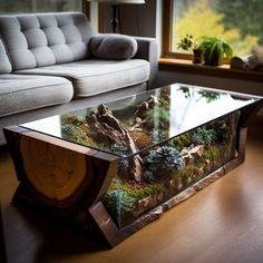 a glass coffee table sitting on top of a hard wood floor next to a couch