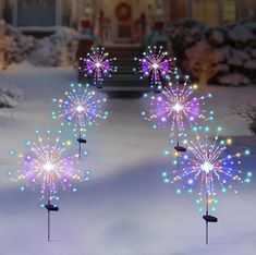 fireworks are lit up in the snow near a house