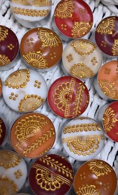 many different colored and gold decorated plates in a box