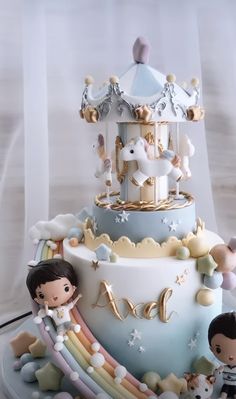 a three tiered cake with figurines on top and a carousel in the background