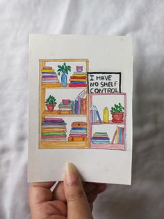 a hand holding up a card that says i have no shelf control with books on it