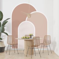 a dining table with four chairs and a plant in front of an arch - shaped wall