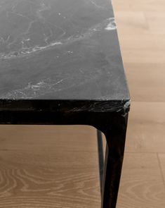 a black marble top coffee table with metal legs