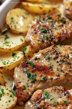 some chicken and potatoes on a plate with parsley sprinkled on top, ready to be eaten