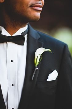 a man in a tuxedo with a boutonniere on his lapel