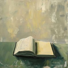 an open book sitting on top of a green table next to a painting with yellow paint