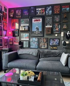 a living room filled with furniture and lots of pictures on the wall above it's coffee table