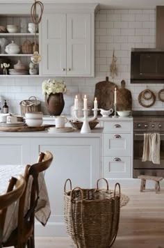 a kitchen filled with lots of white furniture