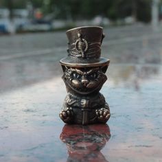 a small metal hat sitting on top of a table