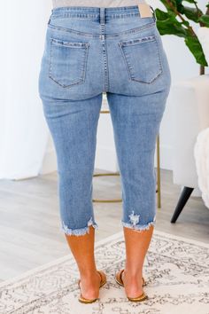 Get ready to turn heads with our Try Harder Capris in blue! These capris feature a button fly and distressed hem, adding a unique touch to your look. So go ahead, and stand out in style! 70% Cotton, 19% Polyester, 9% Rayon, 2% Spandex Summer Cropped Jeans With Frayed Hem In Denim Blue, Medium Wash Cropped Leg Jeans For Day Out, Denim Blue Cropped Jeans With Frayed Hem For Summer, Medium Wash Jeans With Frayed Hem For Day Out, Knee-length Denim Cropped Jeans For Summer, Trendy Knee-length Dark Wash Jeans, Casual Blue Cropped Jeans With Frayed Hem, Cropped Leg Medium Wash Jeans For Day Out, Medium Wash Cropped Jeans For Day Out