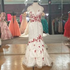 Halter Top Red Floral Designs Scattered Through The Dress With A Mermaid Cut And Subtle Rouging At The Skirt. Prom Dress Color, White Prom, White Prom Dress, A Mermaid, Floral Designs, Red Floral, Halter Top, Lady In Red, Prom Dress