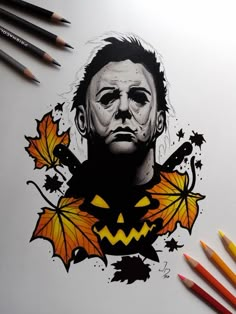 a drawing of a man with pumpkins and leaves on his face, next to colored pencils