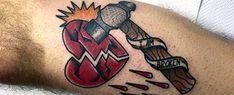 a man with a tattoo on his arm has a hammer in the shape of a heart