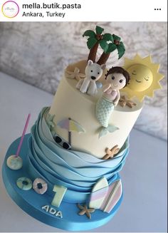 a three tiered cake decorated with an image of people on the beach and palm trees