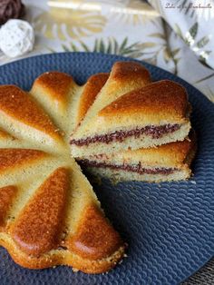 a blue plate topped with a cake cut in half