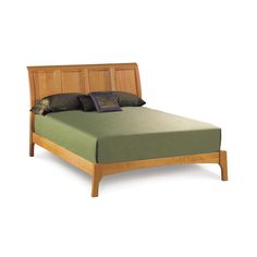 a wooden bed frame with green sheets and pillows on top of it, against a white background