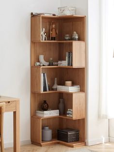 a wooden book shelf sitting in the corner of a room