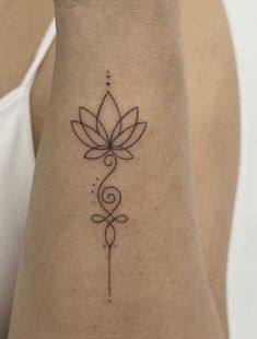 a woman's arm with a small tattoo on the back of her left arm