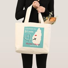 a woman holding a tote bag that says st lucia charlotte and mary's