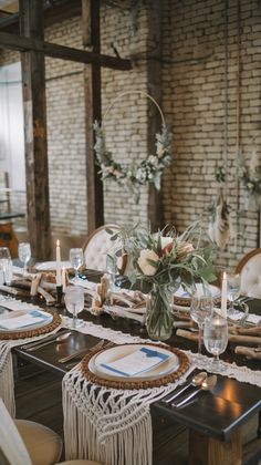 a table set with place settings and candles