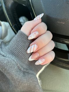 I loved these nails! They had so many winter and Christmas details on them, while staying simple with a white and nude design. The snowflake, candy cane stripes, a french tip, and a gift bow all on one hand!  #nailinspo #winternails #christmasnails #naildesigns #acrylicnails Cute Christmas Nail Designs Almond, Christmas Nails Almond White, Subtle Christmas Nails Almond, Christmas Nails Simple Almond, Candy Cane French Tips, Almond Snowflake Nails, Snowflake French Tip Nails, Pink Candy Cane Nails, Short Almond Christmas Nails