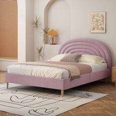 a bedroom with a pink bed and white walls