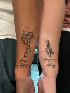 two people with matching tattoos on their arms