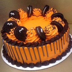 a cake decorated with orange icing and chocolate decorations