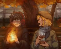 two people sitting next to each other with headphones on and one holding a lit candle