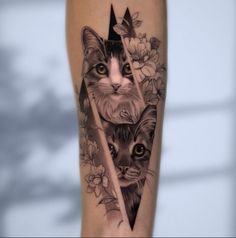 a black and white tattoo with two cats