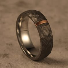 a wedding band that is made out of silver and gold