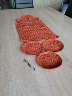 an orange mat on a wooden table with four circles