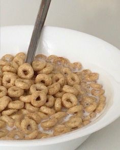 a white bowl filled with cereal sitting on top of a counter