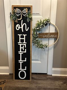 a welcome sign next to a door with a wreath on it and a welcome sign