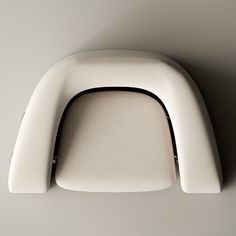 the back end of a white chair against a gray wall with black piping on it