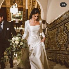 a bride and groom walking down the stairs