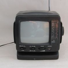 an old fashioned television sitting on top of a table