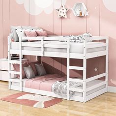 a white bunk bed sitting on top of a wooden floor next to a pink wall