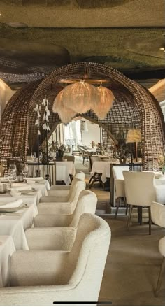 a dining room with white tables and chairs