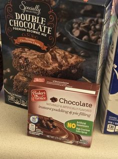 some chocolate brownies are sitting on the counter next to milk and other food items