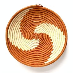 a brown and white basket sitting on top of a table