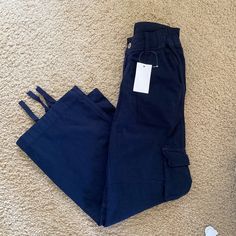 Relaxed, Straight-Leg Cargo Pants With 6 Pockets, Adjustable Elastic Bands At The Waist And Lace Adjusters To The Cuff Of Each Leg. Fabrics: 100% Cotton Measurements: 9"(23 Cm) Rise, 30"(77 Cm) Inseam, 26"(66 Cm) Waist( Stretches) Made In: China Blue Full-length Parachute Pants, Mid-rise Blue Cargo Pants With Pockets, Casual Navy Straight Leg Cargo Pants, Blue Mid-rise Cargo Pants With Pockets, Navy Straight Leg Cargo Pants, Navy Wide Leg Casual Cargo Pants, Casual Navy Straight Leg Bottoms, Navy High Waist Casual Pants, Casual High Waist Navy Pants