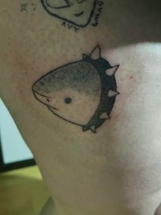 a close up of a person's leg with tattoos on it and an image of a shark